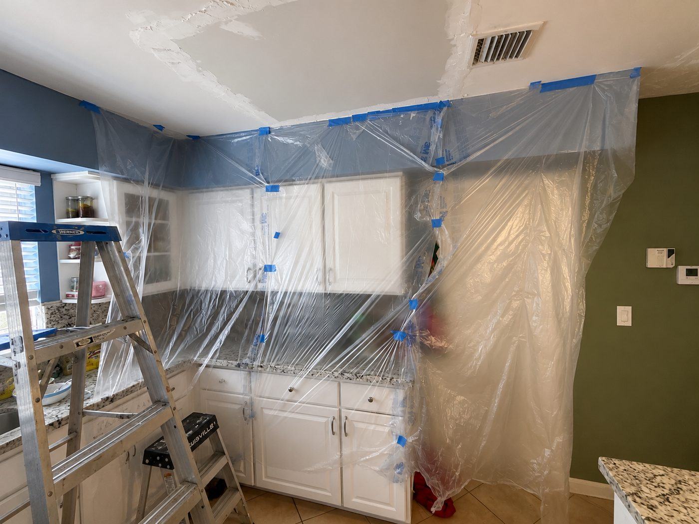 Kitchen ceiling repair prep, area fully protected before work
